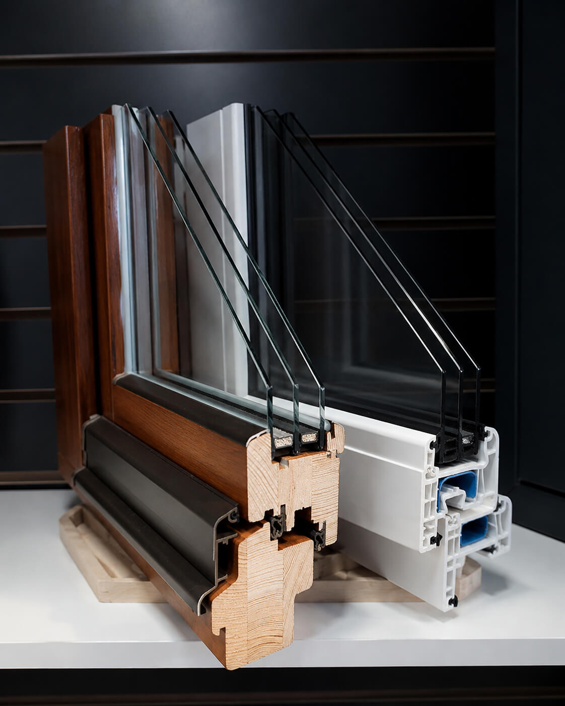 Premium European window cross-section showing triple glazing, wood-clad profile and PVC frame construction.